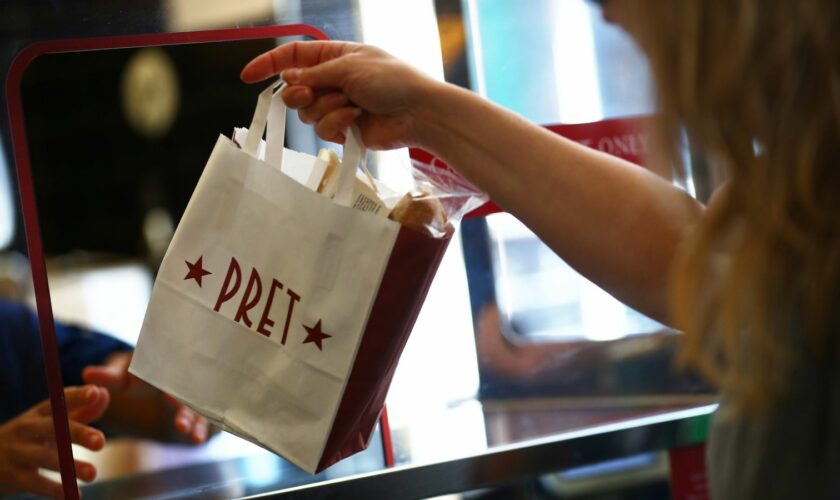 A bag is passed to a customer at Pret a Manger in New Cavendish Street, following the outbreak of the coronavirus disease (COVID-19), London, Britain, June 1, 2020. REUTERS/Hannah McKay