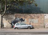 Banksy unveils EIGHTH animal-themed artwork in as many days: Mural of a rhino mounting a Nissan Micra with a traffic cone on its bonnet appears in south east London