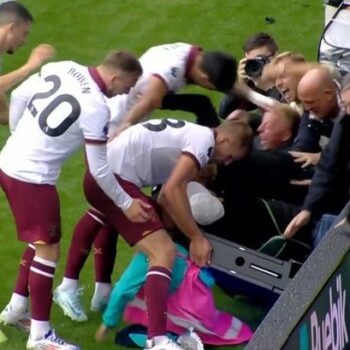 West Ham players rush to crying ball boy's aid after celebrating fans fall through advertising boards