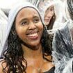 It's really raining in Reading! Music lovers brave the downpours at Berkshire pop gathering - while the sun has been spotted at wind-hit Leeds Festival