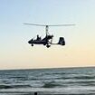 Dramatic moment low-flying gyrocopter crashes into sea near horrified beach sunbathers and swimmers - as officials say it was 'only by chance it did not turn into a tragedy'