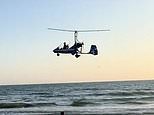 Dramatic moment low-flying gyrocopter crashes into sea near horrified beach sunbathers and swimmers - as officials say it was 'only by chance it did not turn into a tragedy'