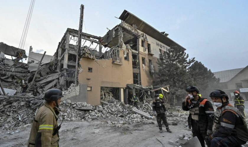 Rescuers stand at a site of a Russian missile strike, amid Russia's attack on Ukraine, in Kryvyi Rih, Ukraine August 27, 2024. REUTERS/Stringer