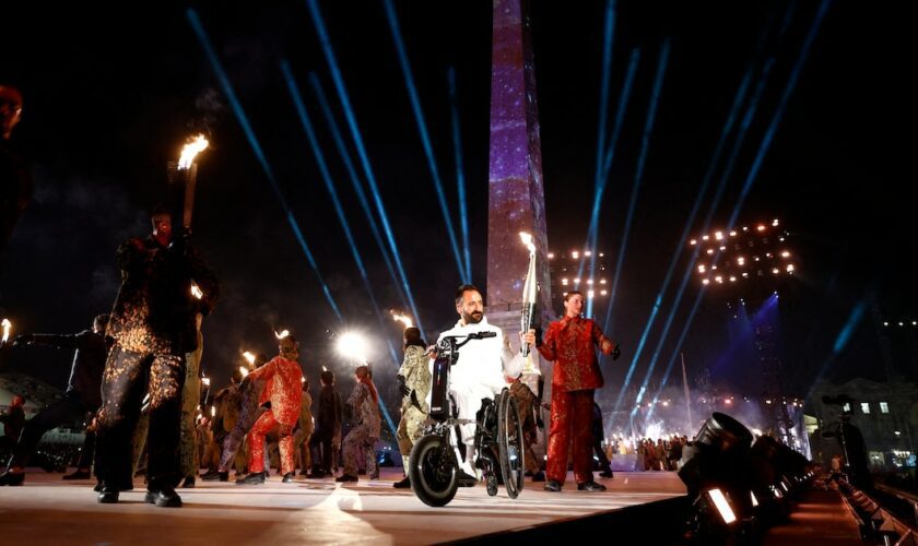 Le porteur du flambeau Michael Jeremiasz porte la flamme paralympique lors de la cérémonie d'ouverture des Jeux paralympiques d'été de Paris 2024 à la place de la Concorde le 28 août 2024 à Paris, France. (Photo de Gonzalo Fuentes-Pool/Getty Images)