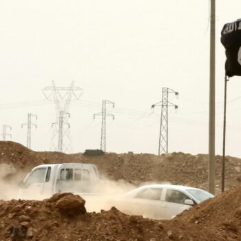 Islamic State militants pass a checkpoint bearing the group's trademark black flag in Iraq. File pic: AP