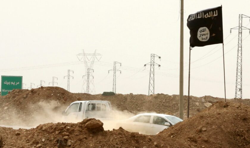 Islamic State militants pass a checkpoint bearing the group's trademark black flag in Iraq. File pic: AP