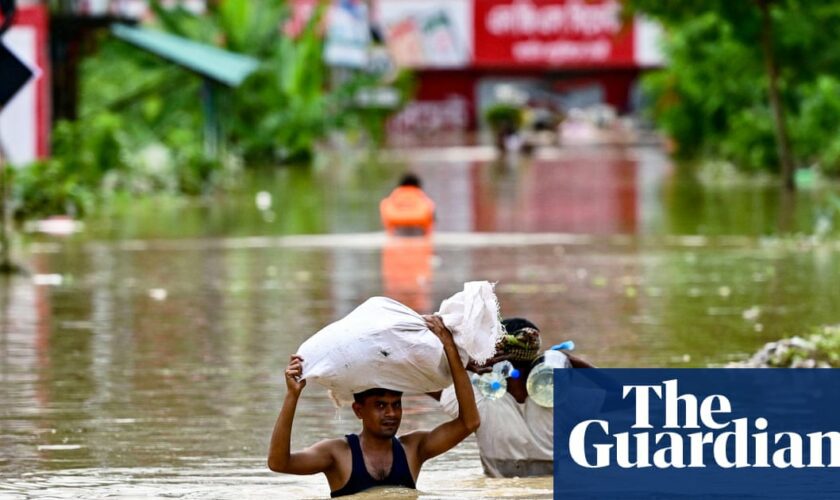 Bangladeshis taking refuge in emergency shelters after heavy flooding