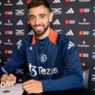 Manchester United midfielder Bruno Fernande smiles as he puts pen to paper on a new contract