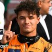 Lando Norris puts up a finger to denote his pole position