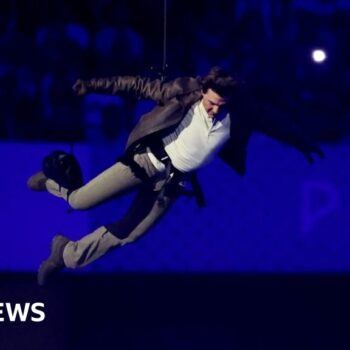 Tom Cruise abseils off stadium roof in daring Olympic finale