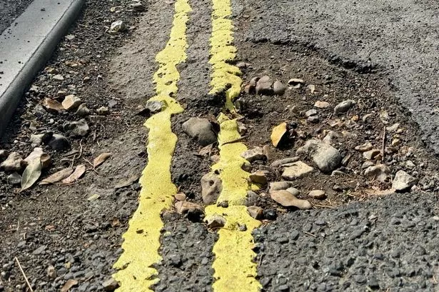 Council hits back after potholes painted with double yellow lines