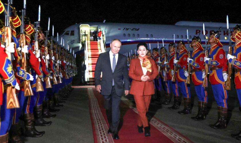 Russian President Vladimir Putin, on red carpet left, walks next to Mongolian Foreign Minister of Mongolia, Batmunkh Battsetseg upon his arrival at Ulaanbaatar's International airport Chinggis Khaan, late Monday, Sept. 2, 2024. (Natalia Gubernatorova, Sputnik, Kremlin Pool Photo via AP)