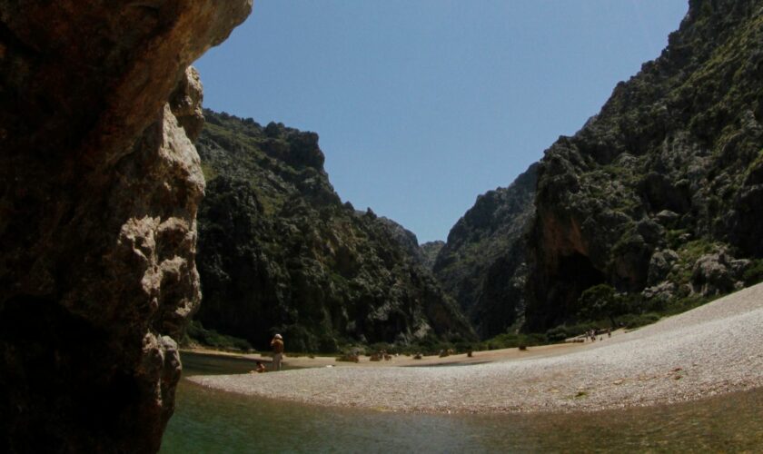 People sunbath at the "Torrent de Pareis" canyon, part of the cultural landscape of the Sierra de Tramuntana, on the northwestern coast of the Spanish Balearic island of Mallorca June 28, 2011. The cultural landscape of the Sierra de Tramuntana (Tramuntana mountain range) was inscribed on UNESCO's World Heritage List on Monday. REUTERS/ Enrique Calvo (SPAIN - Tags: ENVIRONMENT TRAVEL SOCIETY)