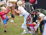 Not another royal sibling spat! Mike Tindall leaps into action to break up play fight between daughter Lena, 6, and son Lucas, 3, as family cheer on Zara at Burghley Horse Trials