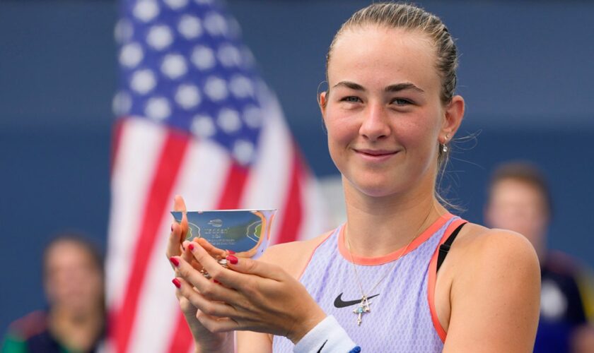 Mika Stojsavljevic holds up the championship cup after winning the final. Pic: AP