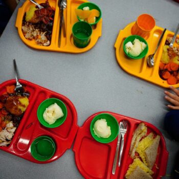 Students eat lunch in the school canteen during the beginning of the roll-out of universal free school meals for primary school children at Ysgol Y Preseli in Pembrokeshire. Most reception pupils in Wales will begin receiving free school meals as they return to school this September. The scheme, which is one of the strands of the Welsh Government's co-operation agreement with Plaid Cymru, is due to be fully rolled out by 2024. Picture date: Wednesday September 7, 2022.