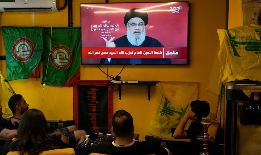 People watch the speech of Hezbollah leader Hassan Nasrallah as they sit in a cafe in the southern suburbs of Beirut, Thursday, Sept. 19, 2024. (AP Photo/Hassan Ammar)