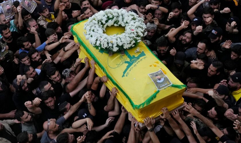 Hezbollah members carry the coffin of their comrade who was killed on Wednesday when a handheld device exploded, during a funeral procession in the southern suburbs of Beirut, Thursday, Sept. 19, 2024. (AP Photo/Hussein Malla)