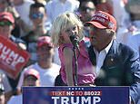 Adorable moment Trump's young granddaughter repeats his famous catchphrase to crowd in North Carolina from behind bulletproof screen - as scandal-hit ally skips rally