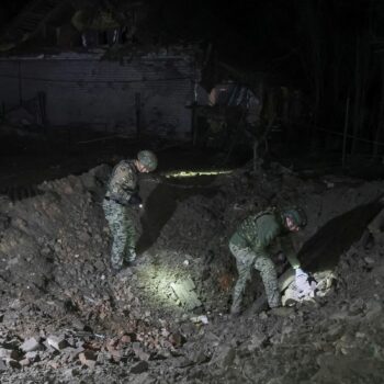 Police experts work at a site of a Russian air strike in Kharkiv on 20 September. Pic: Reuters