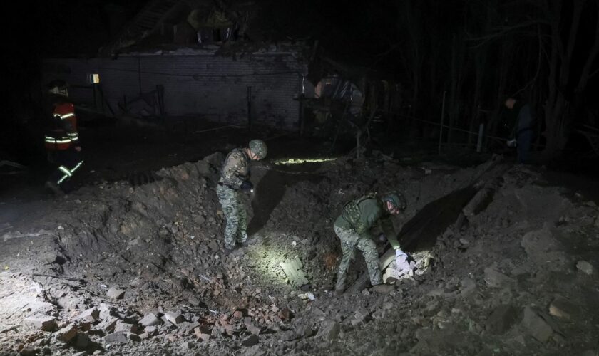 Police experts work at a site of a Russian air strike in Kharkiv on 20 September. Pic: Reuters