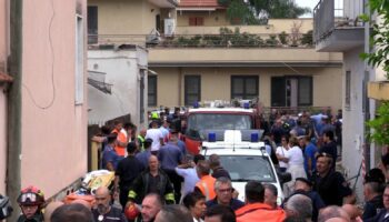 Emergency services attend the site of a building collapse in Saviano, Italy, Sunday Sept, 22, 2024. (LaPresse via AP)