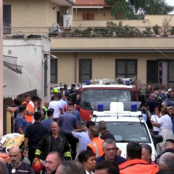 Emergency services attend the site of a building collapse in Saviano, Italy, Sunday Sept, 22, 2024. (LaPresse via AP)