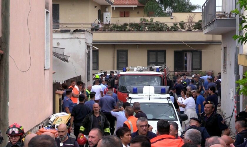 Emergency services attend the site of a building collapse in Saviano, Italy, Sunday Sept, 22, 2024. (LaPresse via AP)