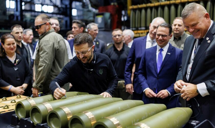 Mr Zelenskyy during his visit to the munitions plant. Pic: Reuters