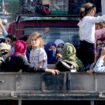 Lebanese citizens who fled from the southern villages sit in a pickup in Beirut. Pic: AP