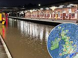 UK weather: Train station is left looking like Venice canal, stranded drivers are saved and dozens of campers are rescued from camp site - with warning of more downpours today