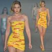 Gigi Hadid is shipping fashion to new heights as she sports mini dress made from DHL parcel tape for Vetements catwalk during Paris Fashion Week