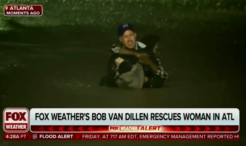 In this image made from a Fox Weather broadcast, meteorologist Bob Van Dillen rescues a woman stuck in floodwaters caused by Hurricane Helene in Atlanta, Friday, Sept. 27, 2024. (Fox Weather via AP)