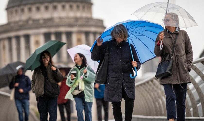 Umbrellas amid wind and rain in London on Friday. Pic: PA