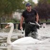 Cars and rail lines submerged as flood risk persists