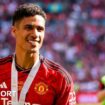 A smiling Raphael Varane at Wembley wearing his FA Cup final winner's medal