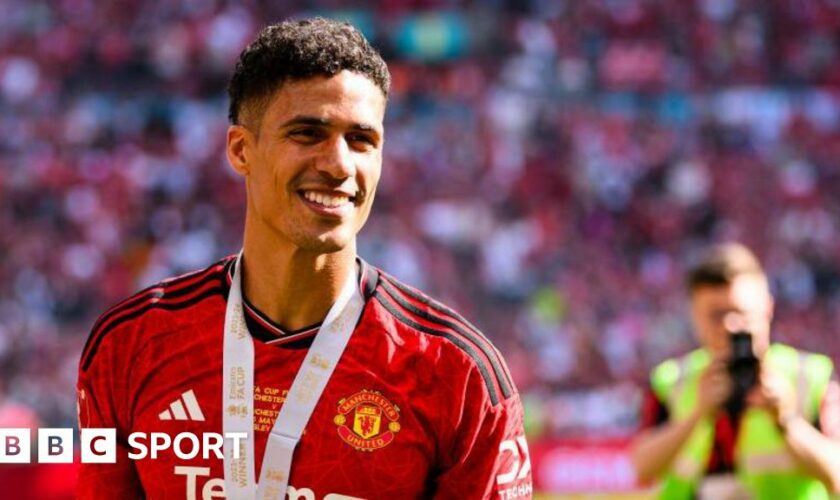 A smiling Raphael Varane at Wembley wearing his FA Cup final winner's medal