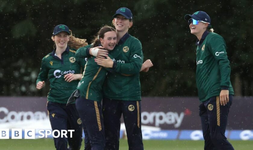 Ireland's cricketers celebrate a wicket v England