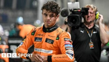 Lando Norris after getting out of the car and taking his helmet off after taking pole position for the Singapore Grand Prix