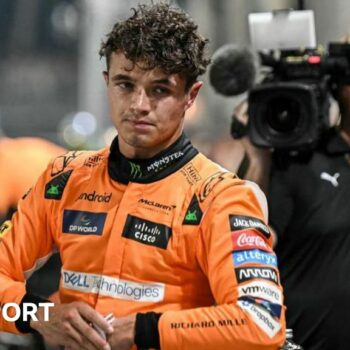 Lando Norris after getting out of the car and taking his helmet off after taking pole position for the Singapore Grand Prix