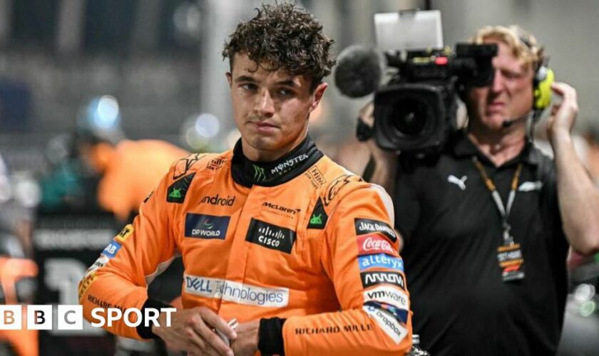 Lando Norris after getting out of the car and taking his helmet off after taking pole position for the Singapore Grand Prix