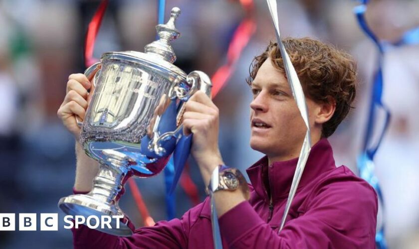 Jannik Sinner of Italy celebrates with the winners trophy after defeating Taylor Fritz