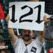 A fan holds up a '121' sign to mark the Chicago White Sox's record defeat