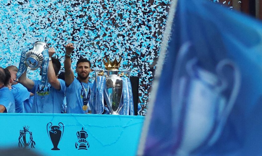 Soccer Football - Manchester City Victory Parade - Manchester, Britain - June 12, 2023 Manchester City's Ruben Dias celebrates with the Premier League trophy during the parade REUTERS/Carl Recine