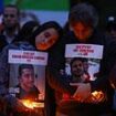 Thousands gather at candlelight vigils across the globe to mark one year since the October 7 massacre: Dozens wipe tears from their eyes as they hold photos of dead loved ones high