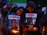 Thousands gather at candlelight vigils across the globe to mark one year since the October 7 massacre: Dozens wipe tears from their eyes as they hold photos of dead loved ones high