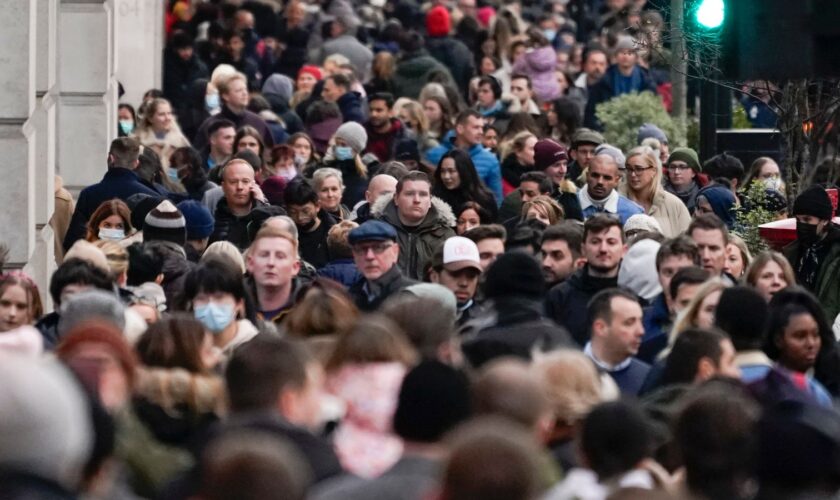 People wear face masks as they walk in Regent Street, in London, Sunday, Nov. 28, 2021. Britain's Prime Minister Boris Johnson said it was necessary to take ...targeted and precautionary measures... after two people tested positive for the new variant in England. He also said mask-wearing in shops and on public transport will be required. (AP Photo/Alberto Pezzali)