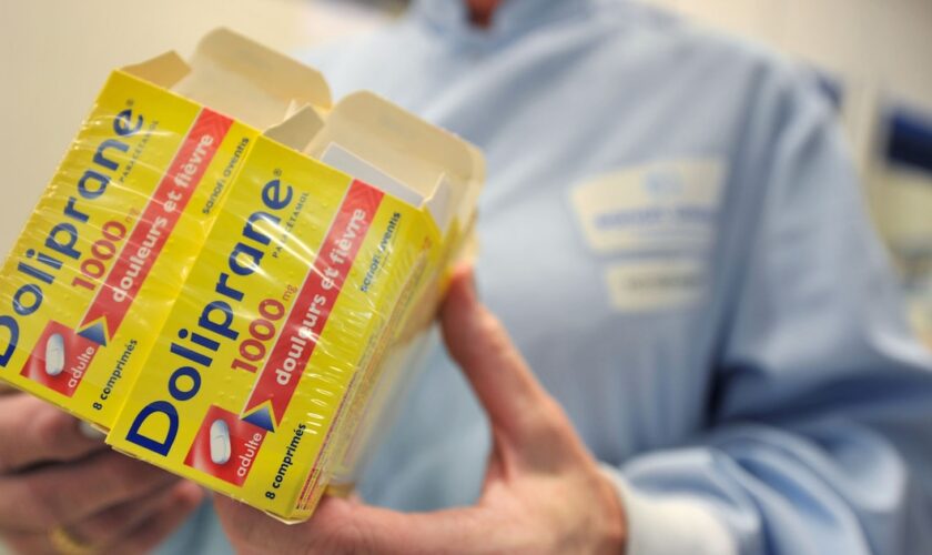 A person poses with boxes of Doliprane, a French over-the-counter drug containing paracetamol, on October 28, 2009 at French pharmaceutical group Sanofi-Aventis site in Lisieux, northern France. The site, created in 1982, is dedicated to the production of medicine containing paracetamol. AFP PHOTO MYCHELE DANIAU