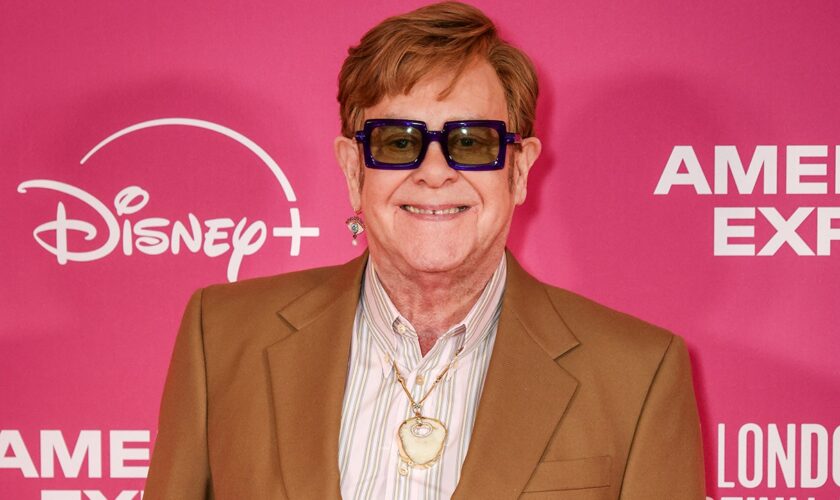 Elton John wears his old kneecap as a pendant around his neck following latest health scare