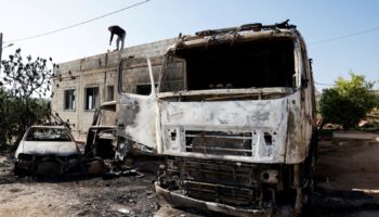 A Palestinian man inspects the damage after Israeli settlers attacked a village in the Israeli-occupied West Bank in April. Pic: Reuters